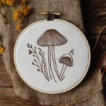 line art mushroom hand embroidery pattern stitched on fabric