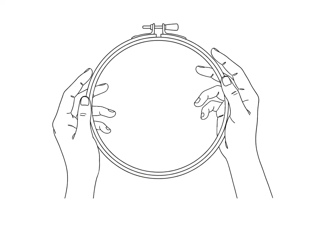 two hands holding an empty round wooden embroidery hoop