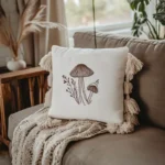 white mushroom embroidered pillow on sofa with soft white throw blanket